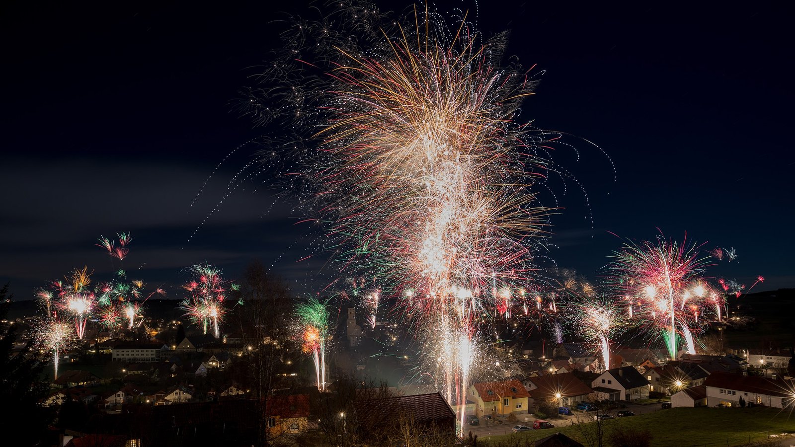 Multiple multi-colored fireworks over a Swabian Village taken in 2018.